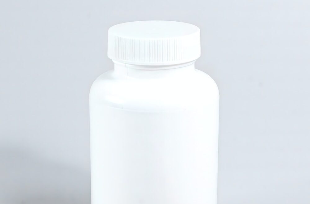 Supplements Beside White Plastic Bottle