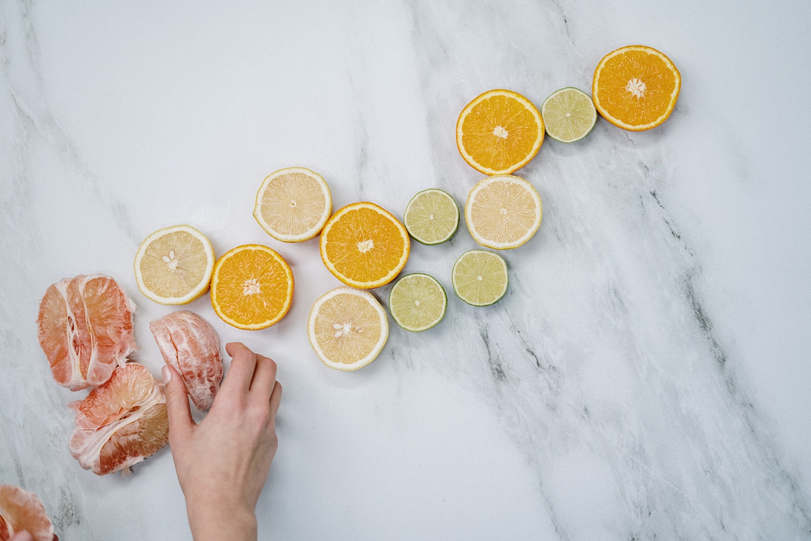 Sliced Orange Fruits on White Table